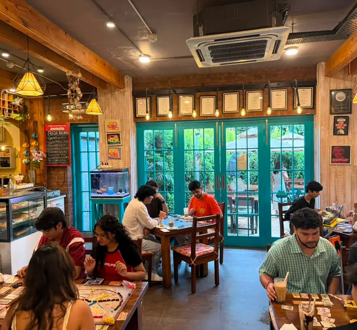 Board-game night at a café, hosted by a SyncTrip club