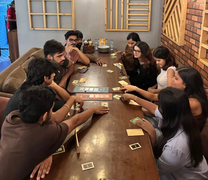 A table of new friends playing a card game